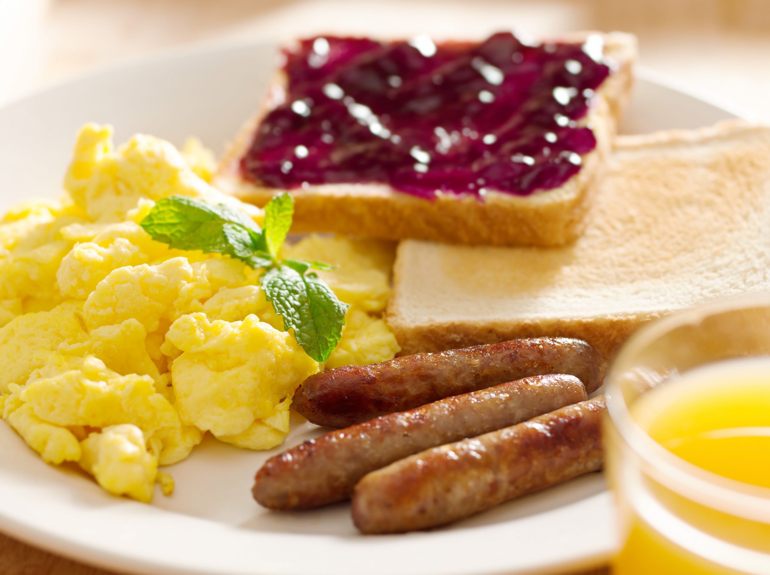 breakfast food - american style breakfast with scrambled eggs, sausage and toast.
